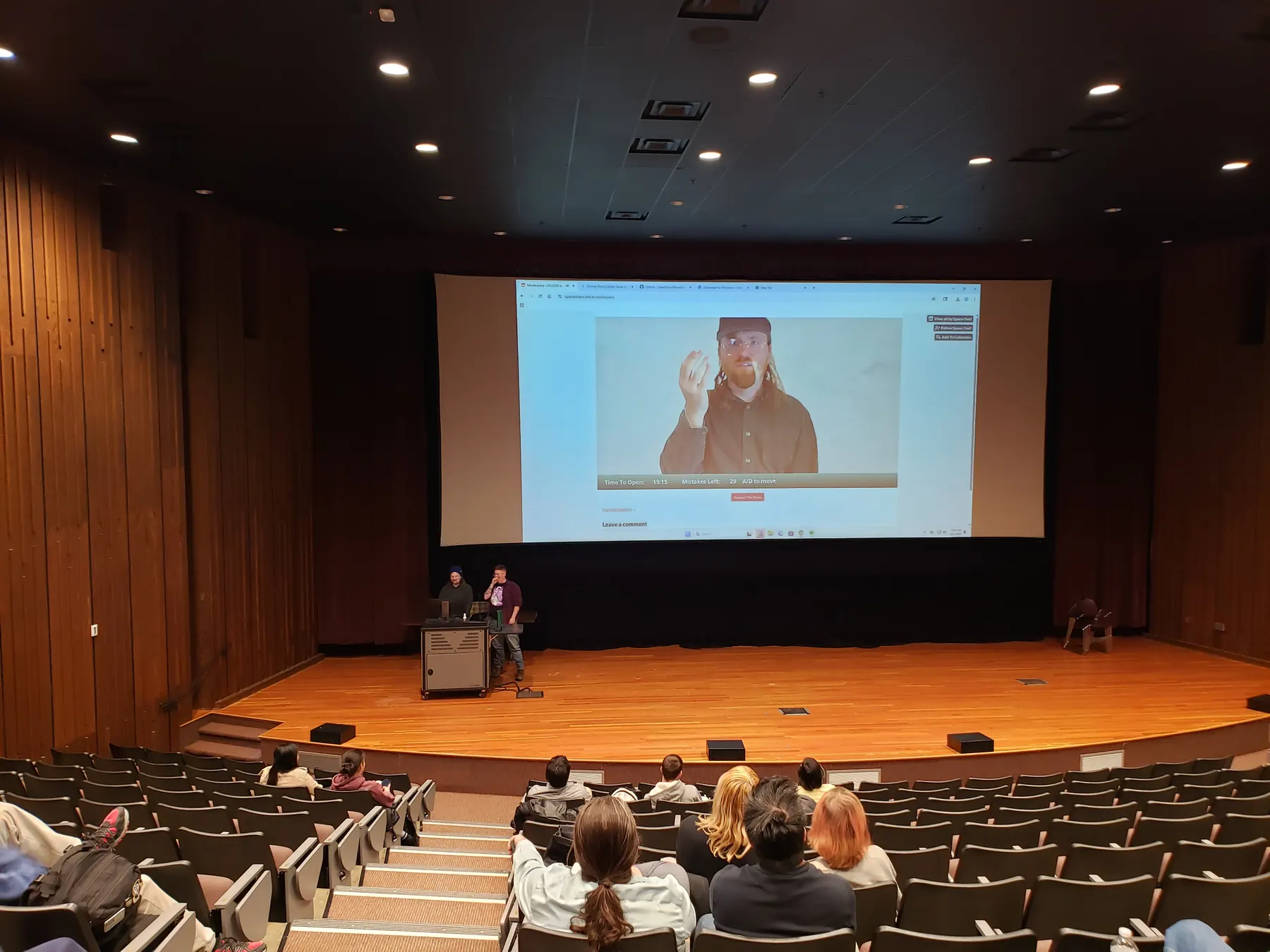 Students presenting during the PFW Global Game Jam closing showcase in an auditorium
