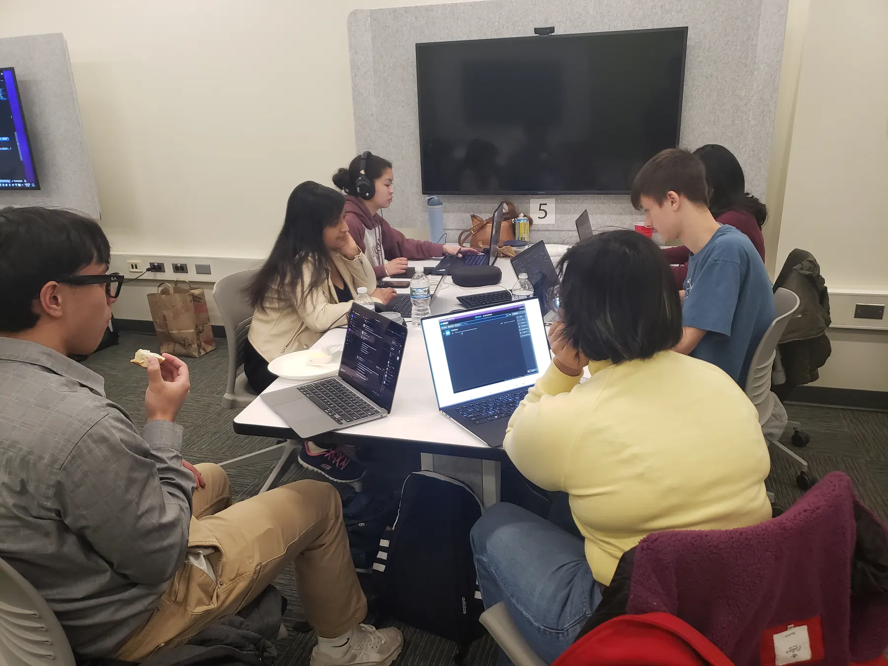 A Global Game Jam team working around laptops in a PFW computer lab